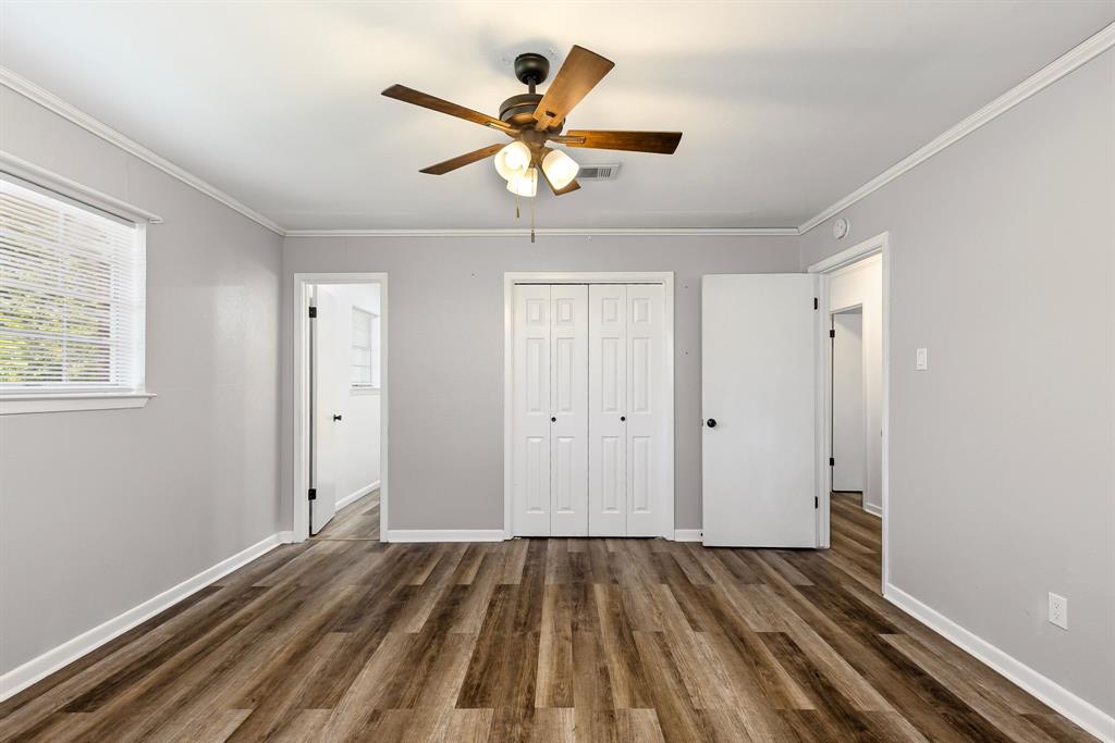 148 Royal Lane Commerce, TX 75428 - Photo 19 of 38 wooden floor in an empty room with a window