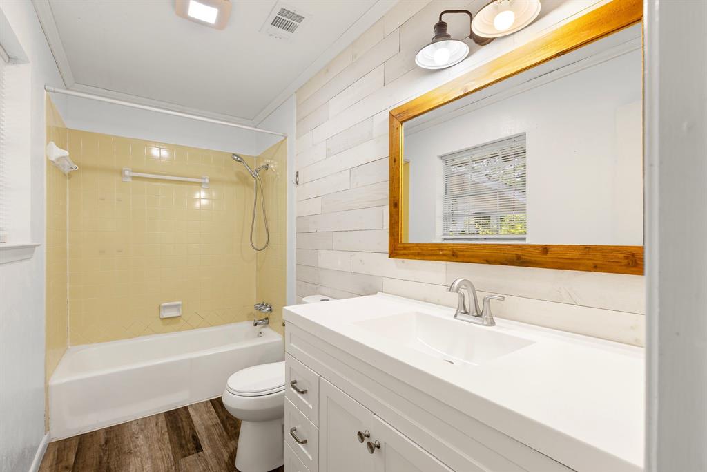 148 Royal Lane Commerce, TX 75428 - Photo 20 of 38 a bathroom with a sink a toilet and shower