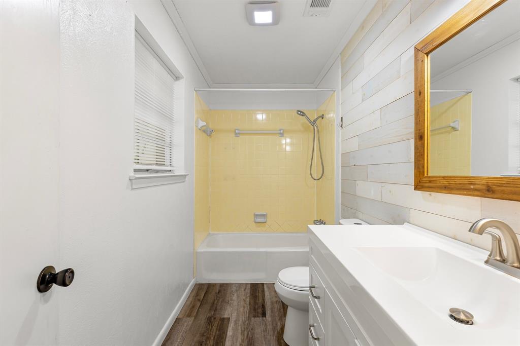 148 Royal Lane Commerce, TX 75428 - Photo 21 of 38 a bathroom with a sink a toilet and shower