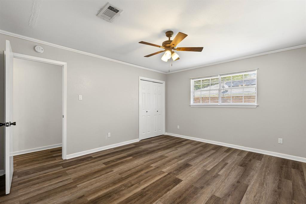 148 Royal Lane Commerce, TX 75428 - Photo 22 of 38 a view of empty room with wooden floor and fan