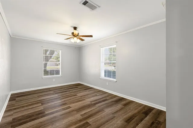 a view of a room with a ceiling fan and a window