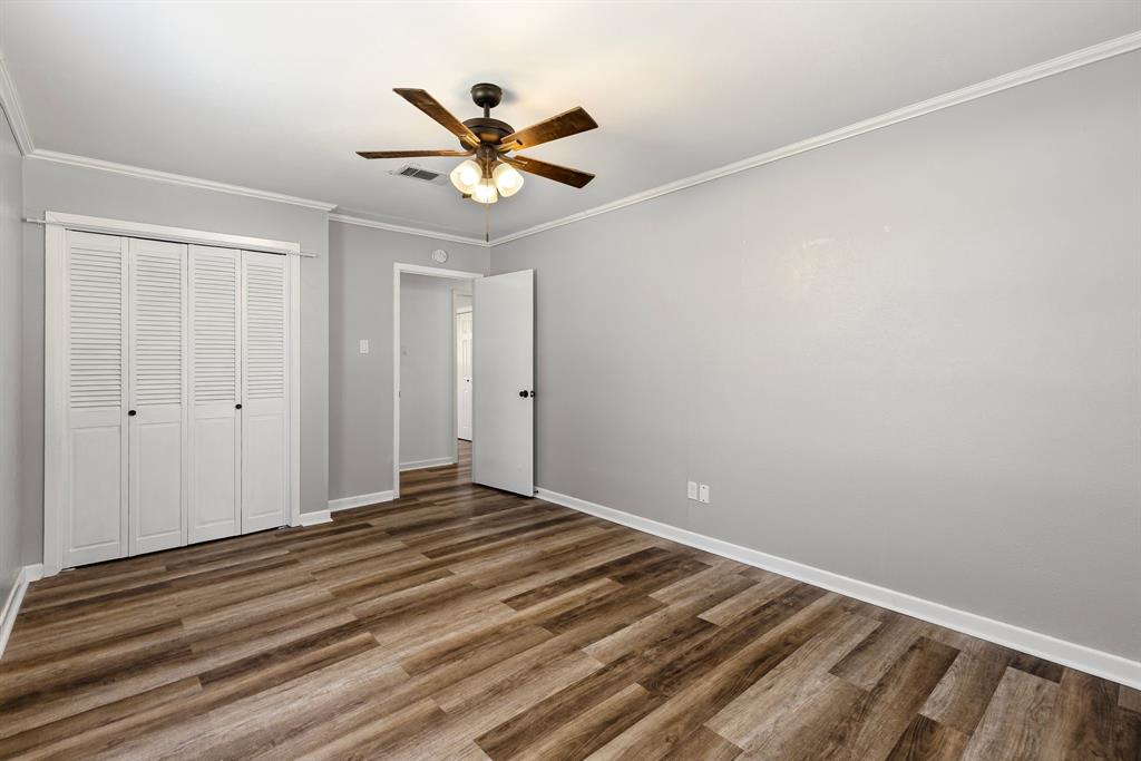 148 Royal Lane Commerce, TX 75428 - Photo 24 of 38 a view of a big room with wooden floor and closet area