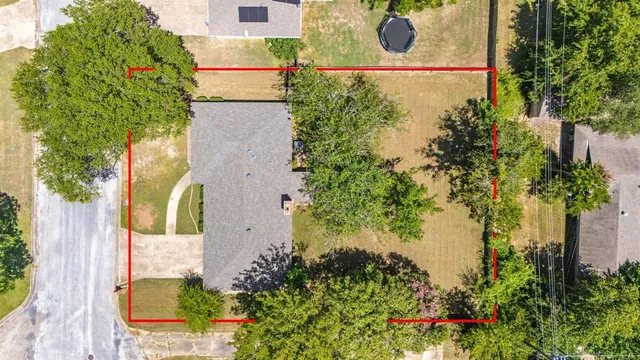 an aerial view of a house with a yard and garden