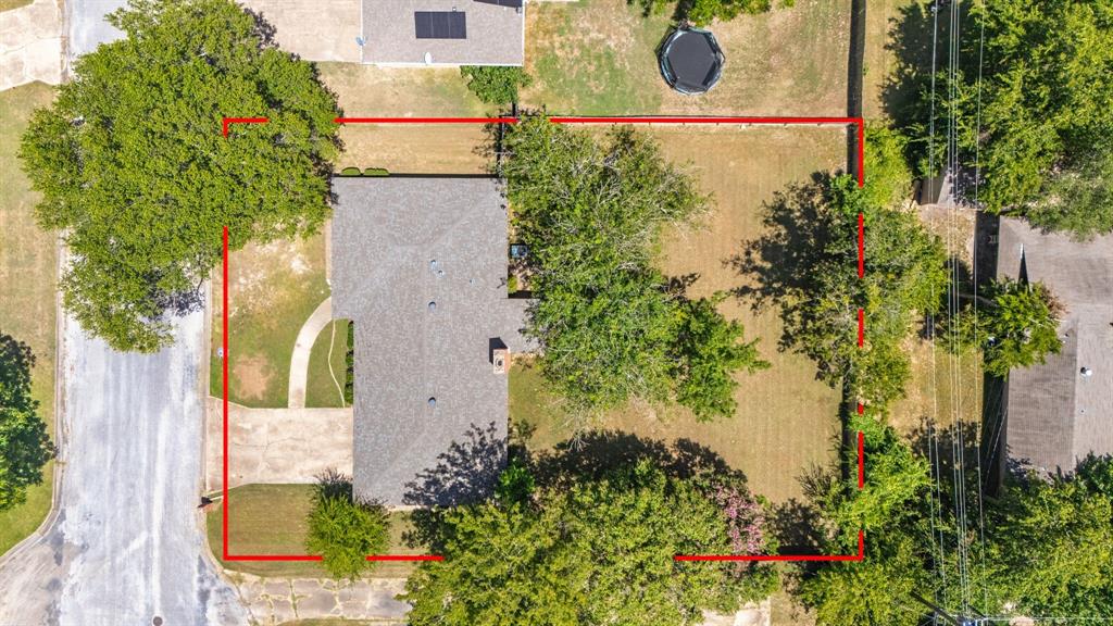 148 Royal Lane Commerce, TX 75428 - Photo 37 of 38 an aerial view of a house with a yard and garden