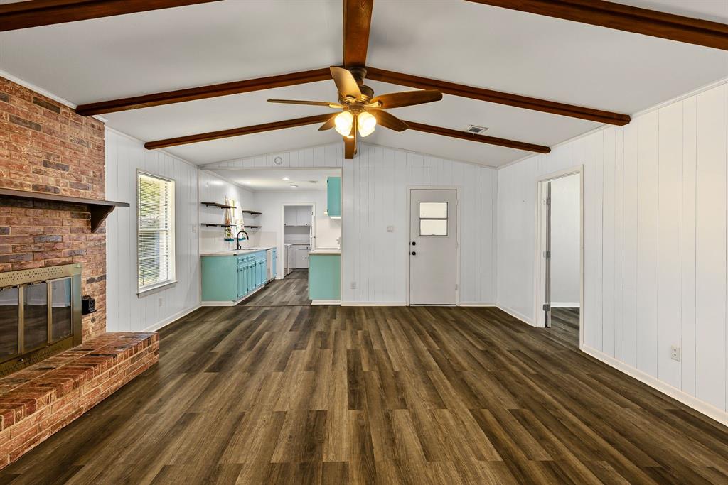 148 Royal Lane Commerce, TX 75428 - Photo 4 of 38 a view of empty room with wooden floor and fan