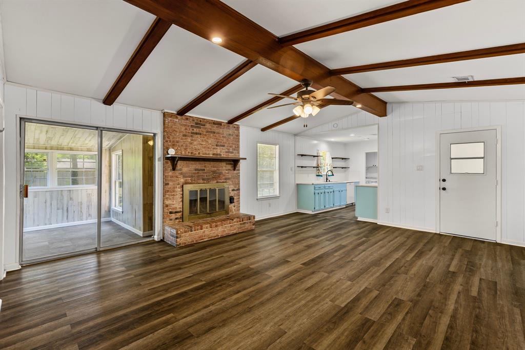 148 Royal Lane Commerce, TX 75428 - Photo 5 of 38 a view of empty room with wooden floor and fireplace
