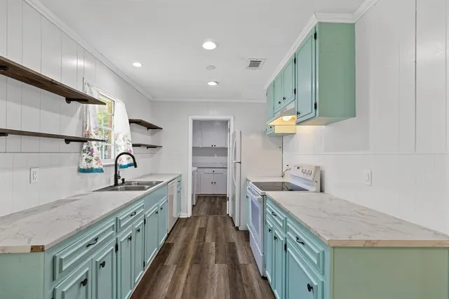 a kitchen with sink cabinets and stove