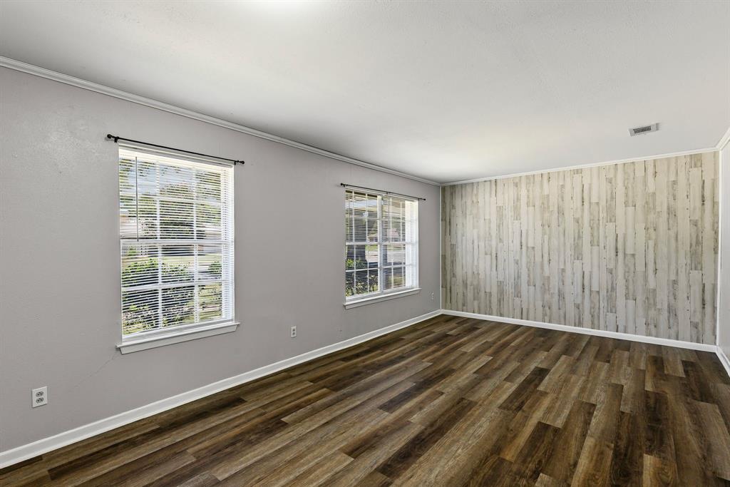 148 Royal Lane Commerce, TX 75428 - Photo 10 of 38 a view of an empty room with wooden floor and a window