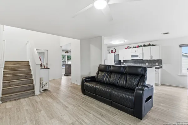 a living room with furniture and wooden floor