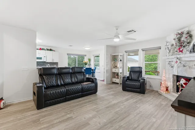 a living room with furniture fireplace and flat screen tv