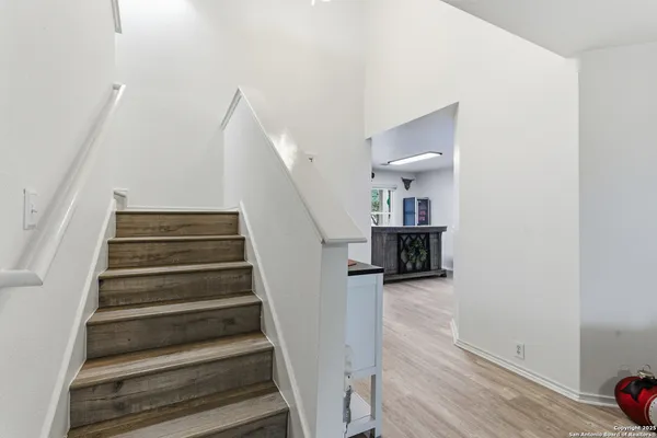 a view of entryway and hall with wooden floor