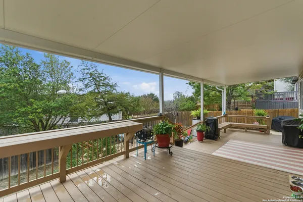 a view of a balcony with couch and wooden floor