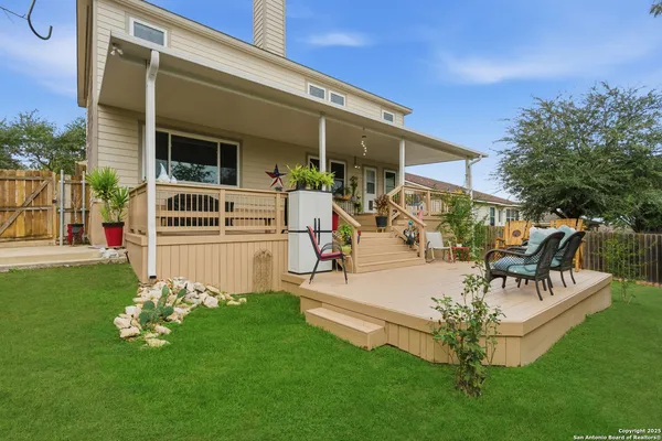 a view of a house with a backyard porch and sitting area