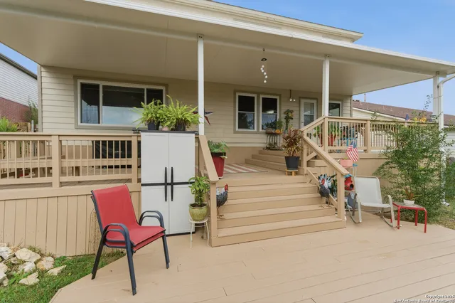 a view of a chair and tables in the balcony