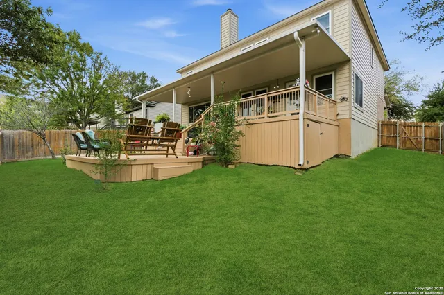 a view of a house with backyard and sitting area