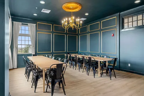 a view of a dining room with furniture and chandelier