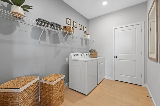 a kitchen with kitchen island white cabinets a sink a stove and a refrigerator