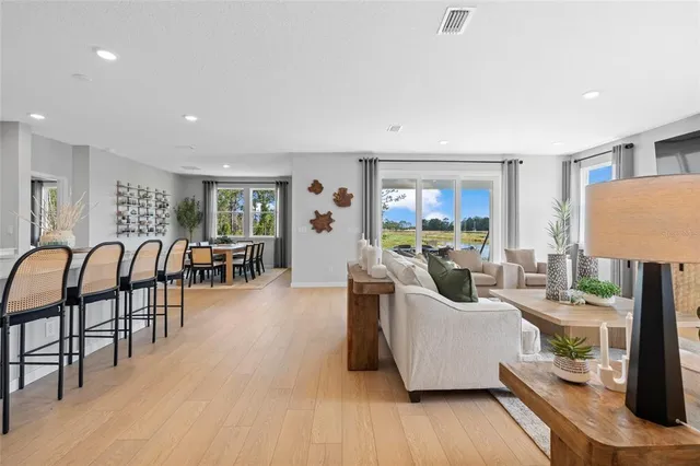 a view of a hallway with a couch and wooden floor