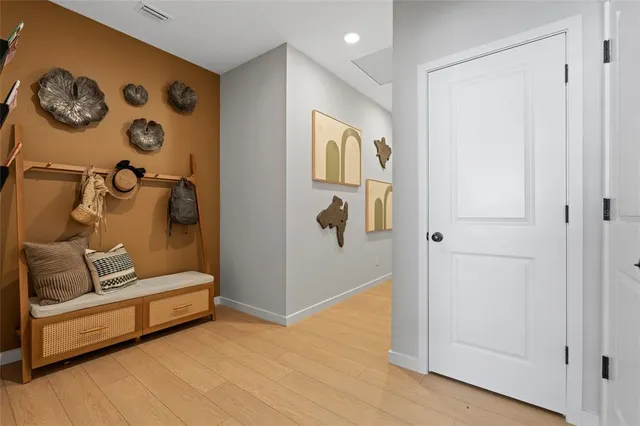 a dining room with furniture and a floor to ceiling window