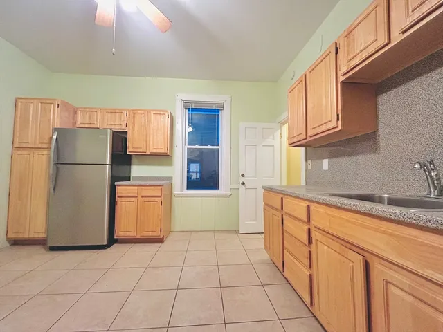 a kitchen with a refrigerator sink stove and cabinets