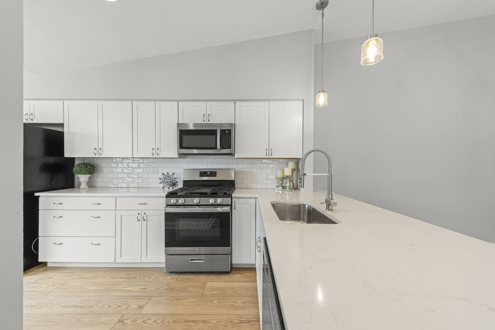 1802 77th Street Naperville, IL 60565 - Photo 13 of 29 a kitchen with stainless steel appliances a stove a sink and white cabinets