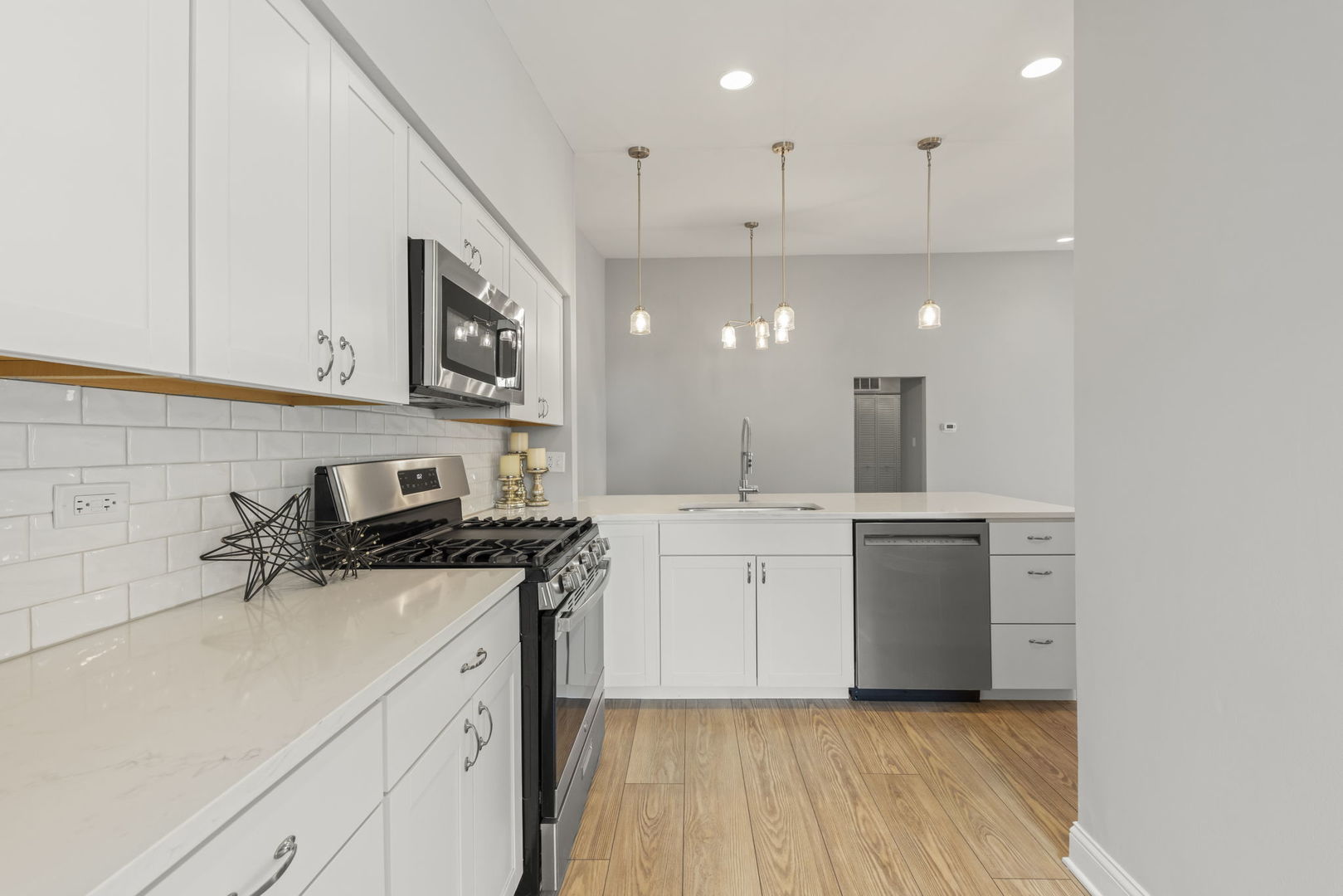 1802 77th Street Naperville, IL 60565 - Photo 14 of 29 a kitchen with a sink stainless steel appliances and white cabinets