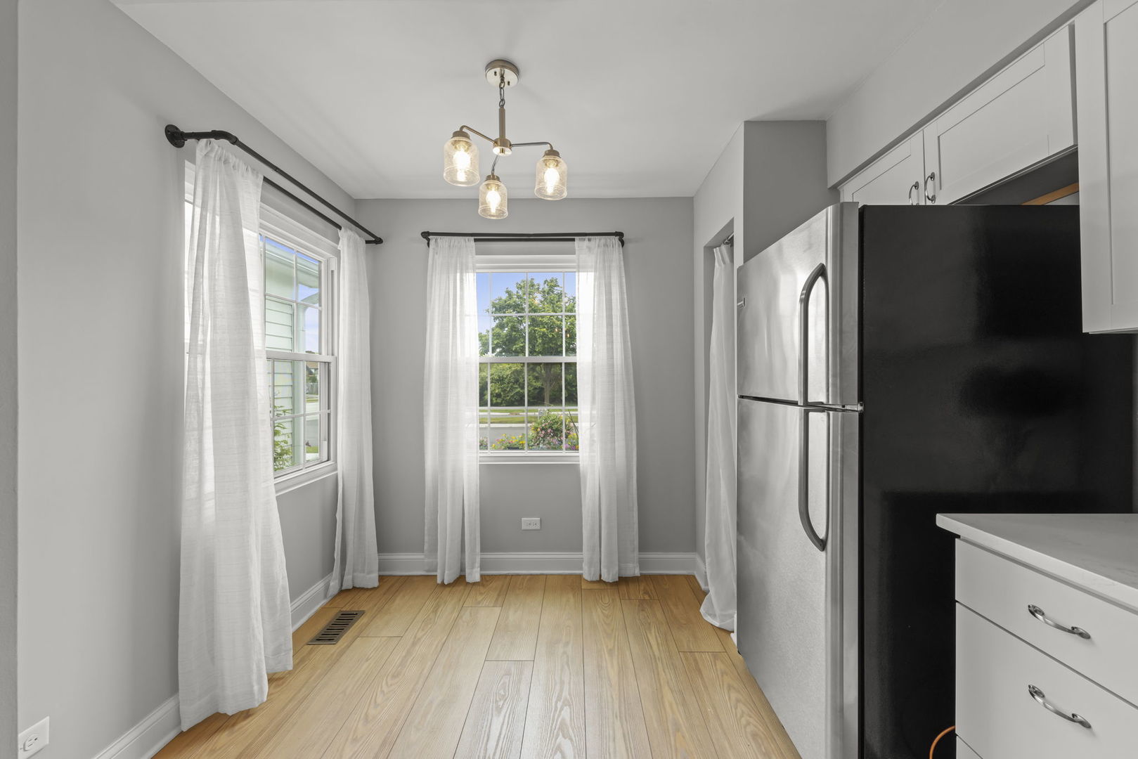 1802 77th Street Naperville, IL 60565 - Photo 15 of 29 a view of a kitchen with a refrigerator and a window