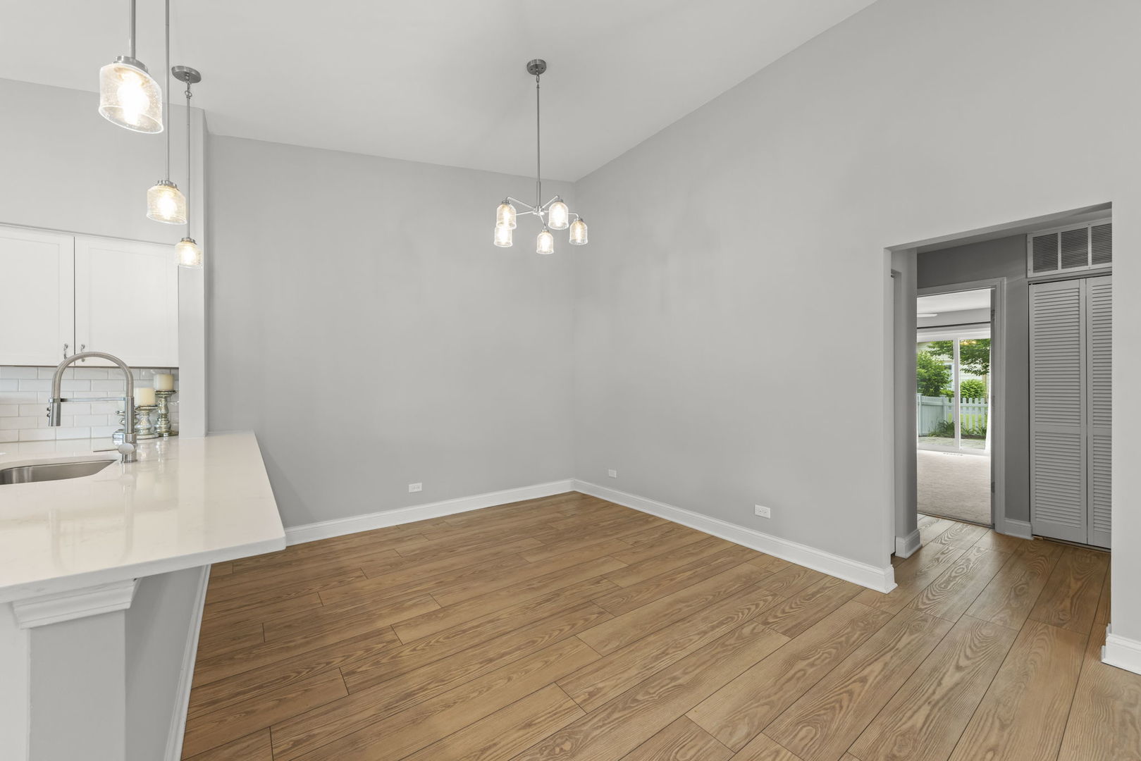 1802 77th Street Naperville, IL 60565 - Photo 9 of 29 a view of a kitchen with a sink and dishwasher with wooden floor