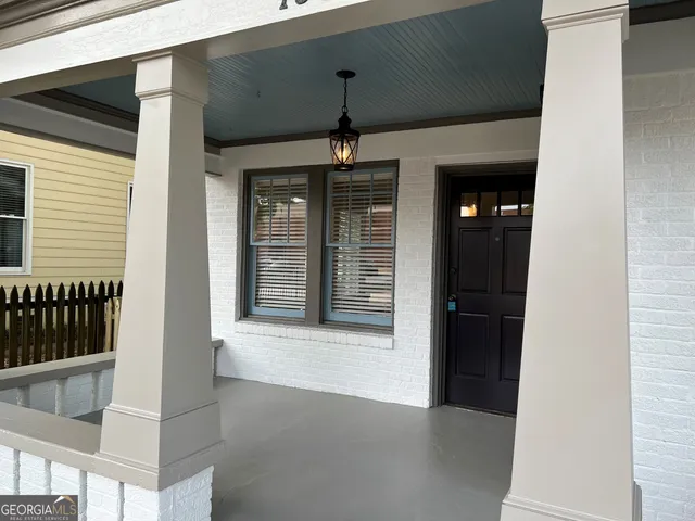 a view of a hallway with wooden floor and windows