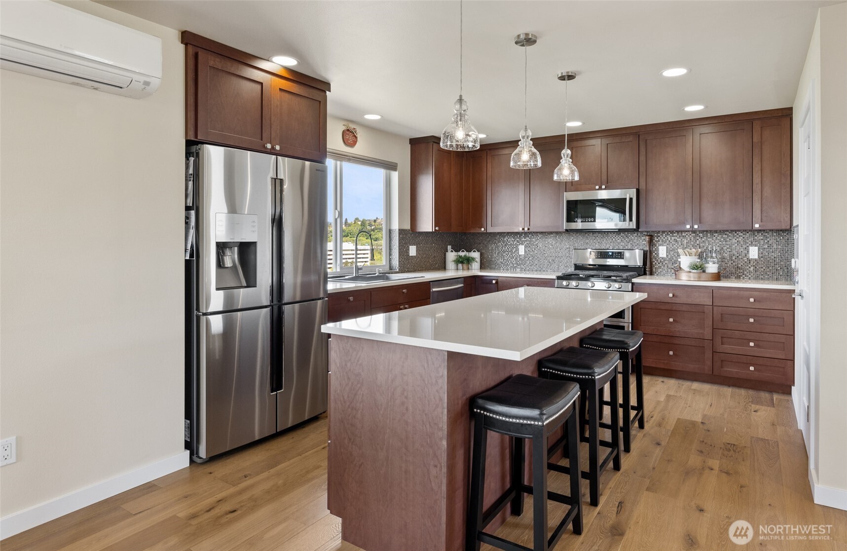 1409 Shattuck Avenue South Renton, WA 98055 - Photo 15 of 37 a kitchen with stainless steel appliances a sink a stove a refrigerator cabinets and a dining table