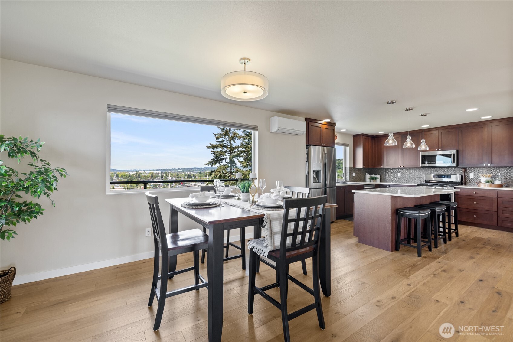 1409 Shattuck Avenue South Renton, WA 98055 - Photo 21 of 37 a view of a dining room with furniture and wooden floor