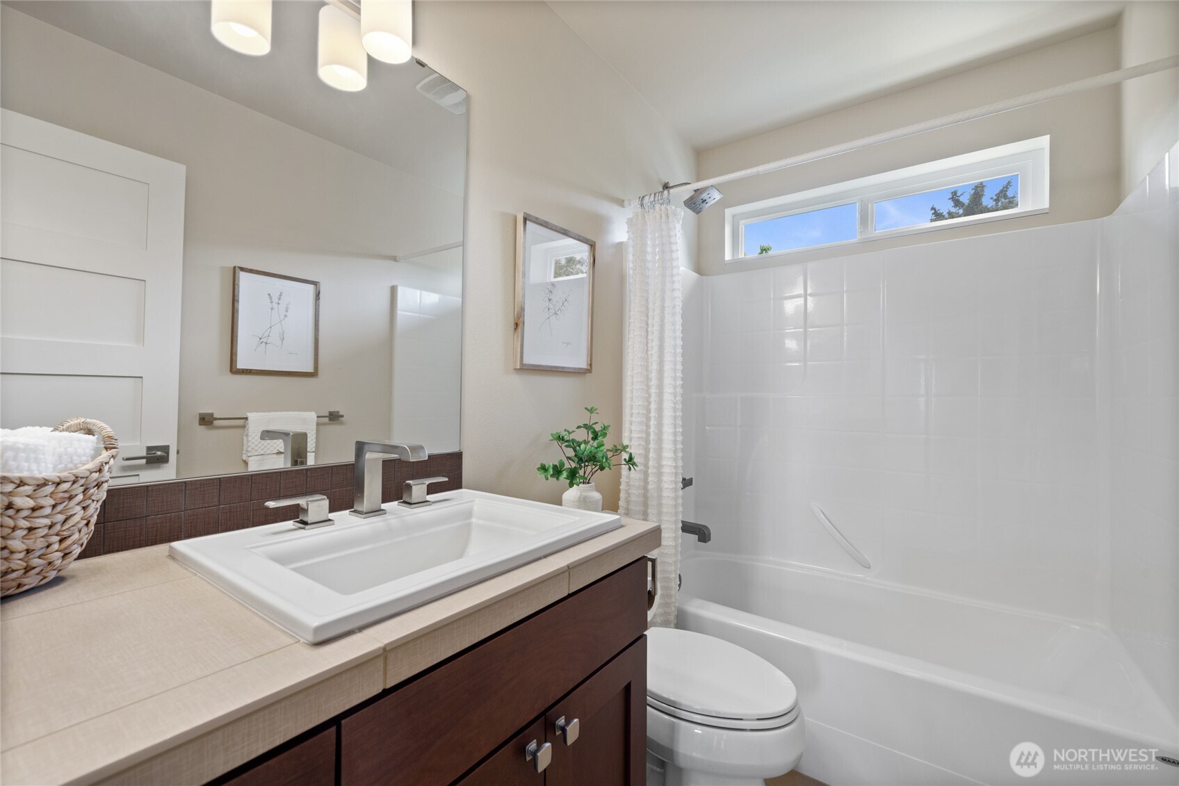 1409 Shattuck Avenue South Renton, WA 98055 - Photo 10 of 37 a bathroom with a sink a toilet and shower