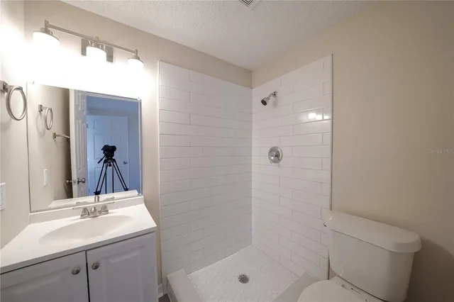 a kitchen with stainless steel appliances white cabinets a sink a stove a microwave and wooden floors