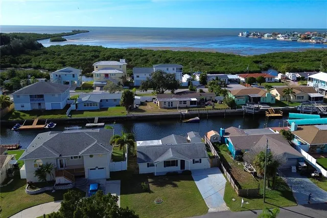 an aerial view of a house with a swimming pool outdoor seating and yard