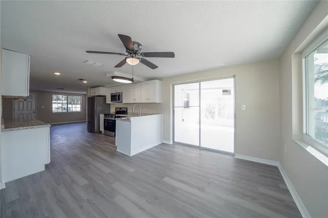 a view of kitchen with cabinets and wooden floor