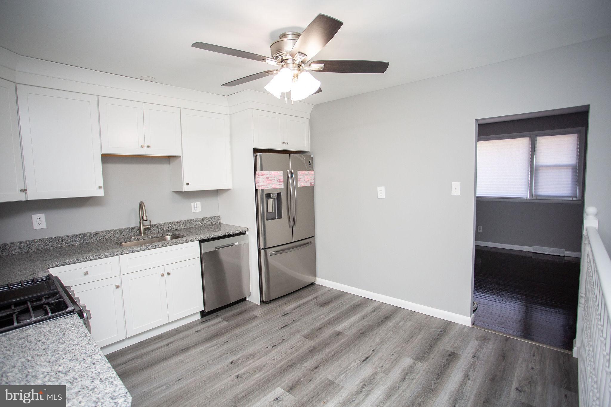 119 Trinity Avenue Blackwood, NJ 08012 - Photo 12 of 37 a kitchen with a sink a refrigerator and cabinets