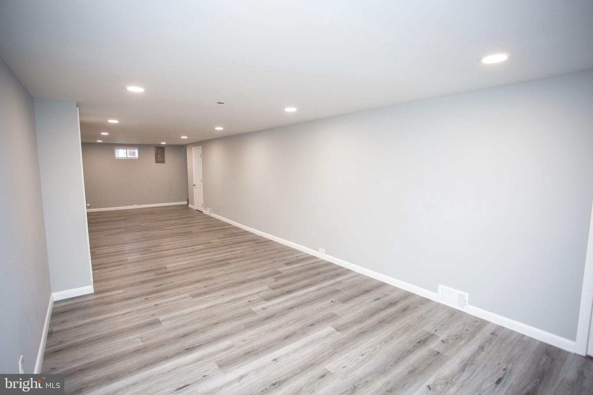 119 Trinity Avenue Blackwood, NJ 08012 - Photo 16 of 37 an empty room with wooden floor and entrance