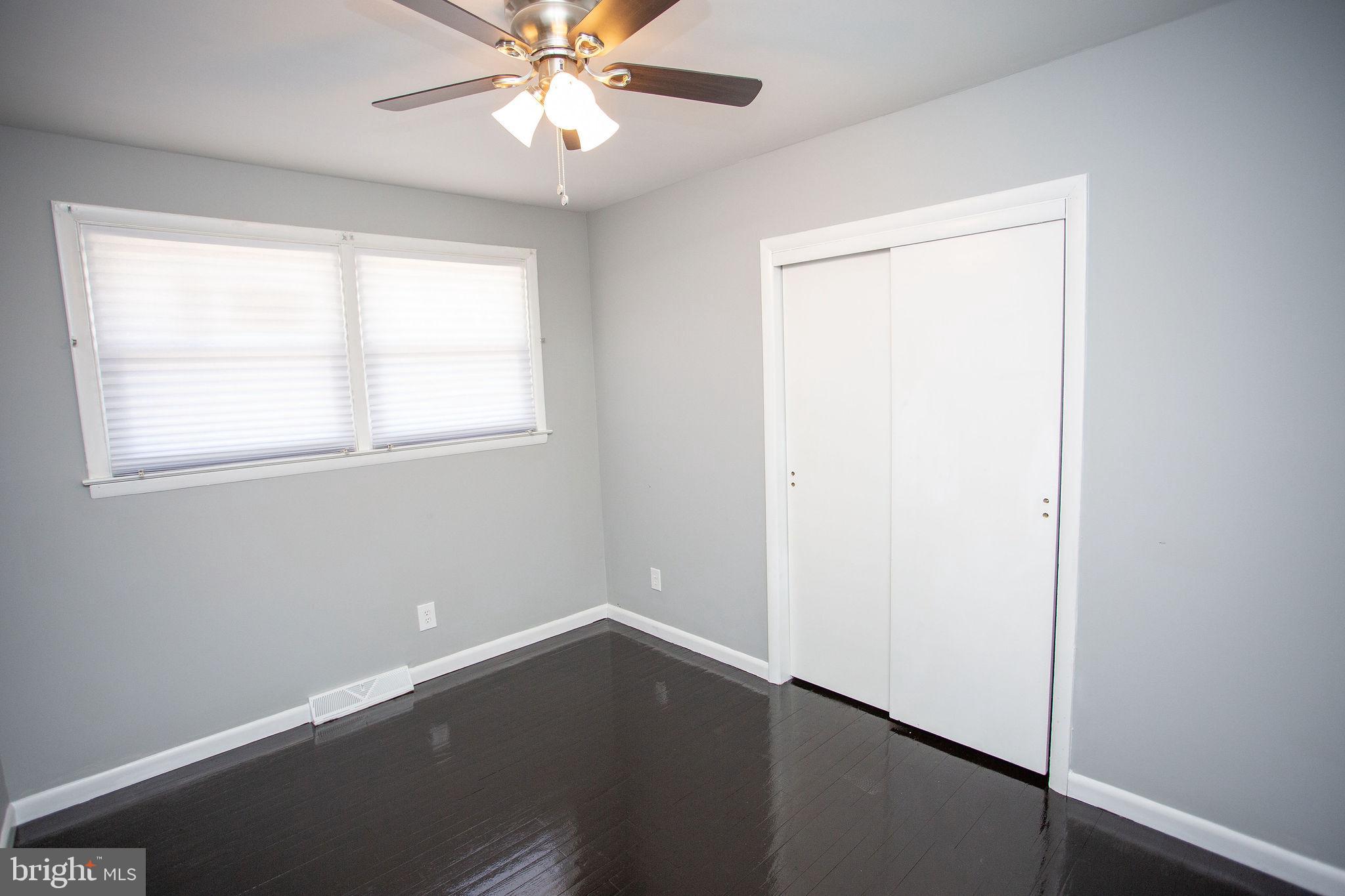 119 Trinity Avenue Blackwood, NJ 08012 - Photo 28 of 37 an empty room with wooden floor closet and windows