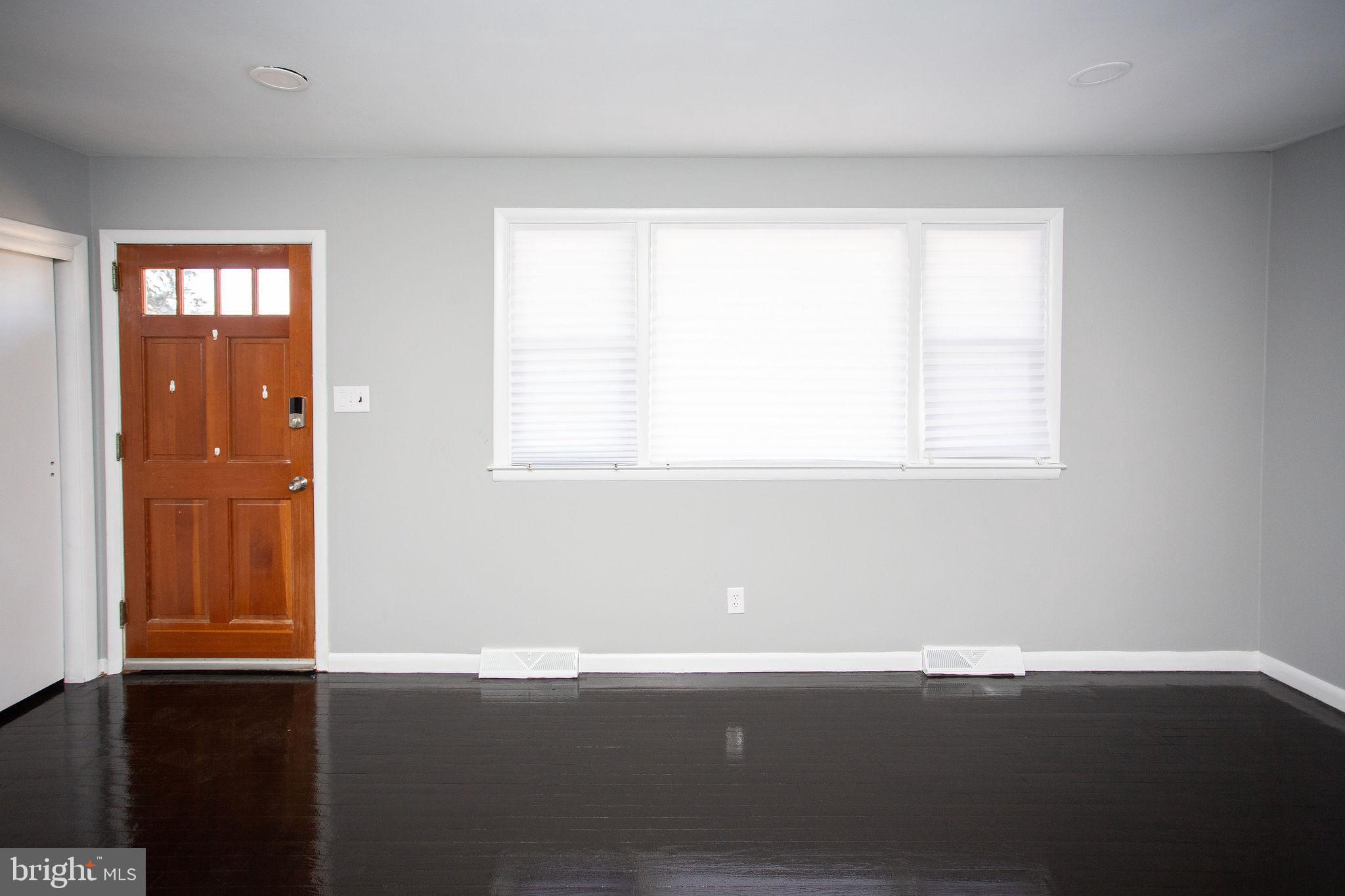 119 Trinity Avenue Blackwood, NJ 08012 - Photo 5 of 37 an empty room with wooden floor and windows