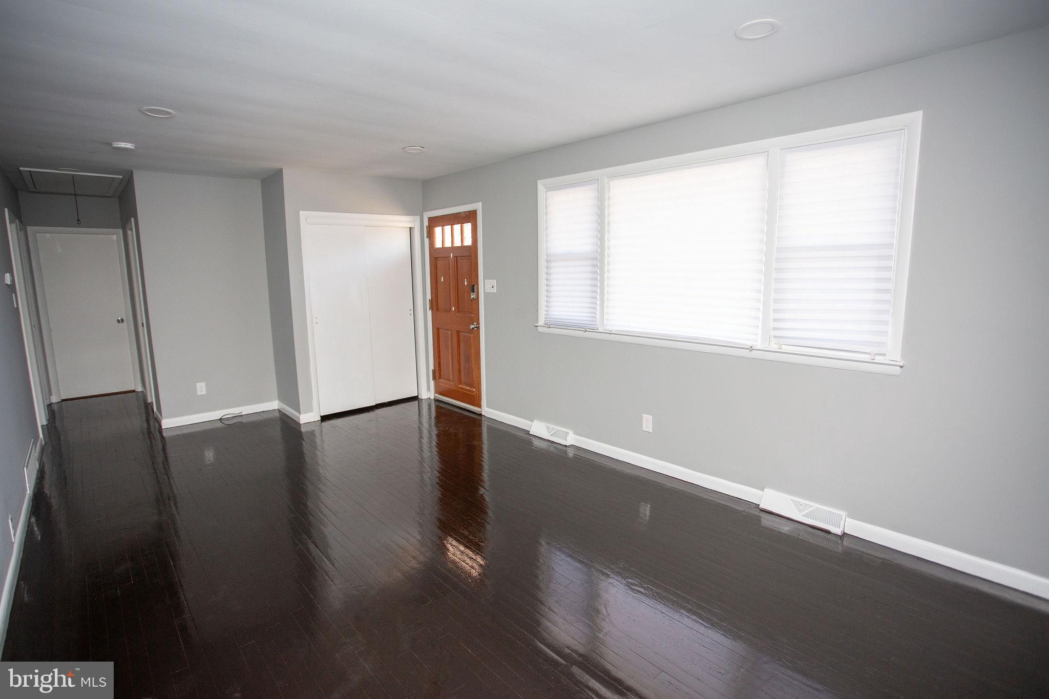 119 Trinity Avenue Blackwood, NJ 08012 - Photo 6 of 37 a view of an empty room with wooden floor and a window
