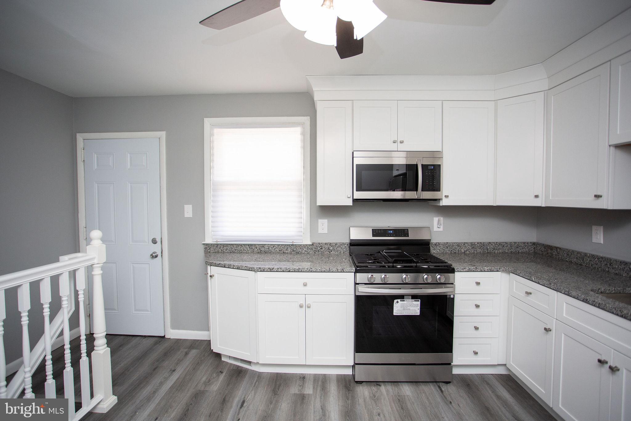 119 Trinity Avenue Blackwood, NJ 08012 - Photo 9 of 37 a kitchen with granite countertop white cabinets white stainless steel appliances and a sink