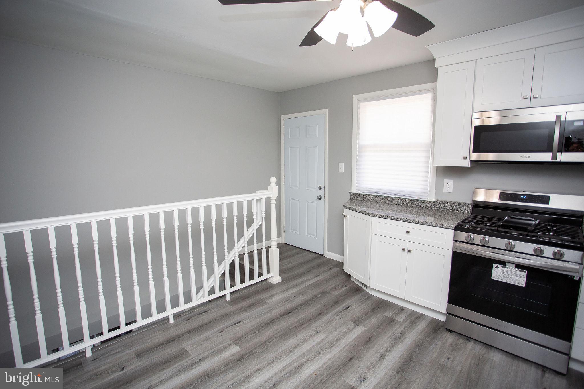 119 Trinity Avenue Blackwood, NJ 08012 - Photo 10 of 37 a kitchen with stainless steel appliances granite countertop a stove a sink and a microwave