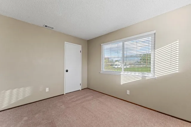 a view of an empty room with windows