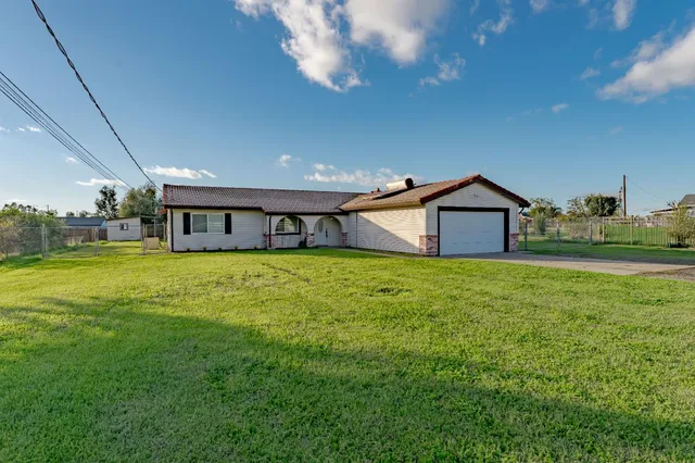 a front view of house with yard and green space