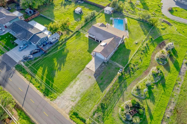 a kitchen with stainless steel appliances granite countertop a stove top oven a refrigerator a sink and dishwasher with wooden cabinets