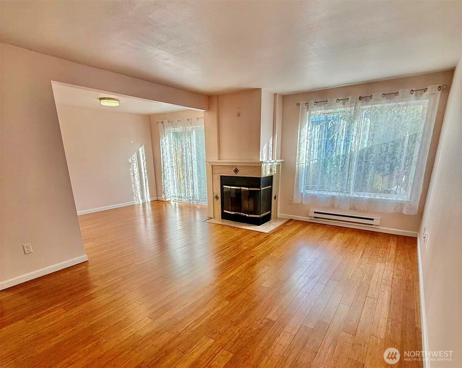927 132nd Street Southwest, Unit D3 Everett, WA 98204 - Photo 3 of 20 a view of a livingroom with wooden floor and a fireplace