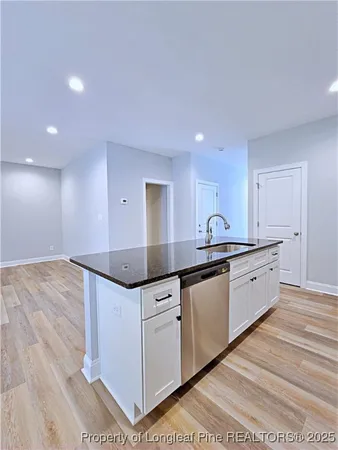 an empty room with ceiling fan and window
