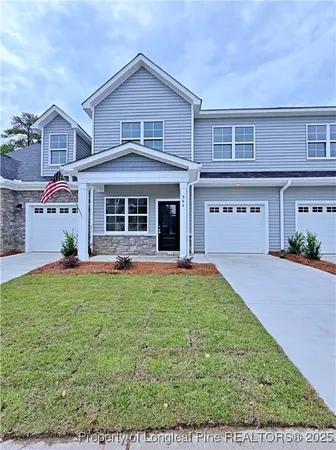 a view of empty room with wooden floor and fireplace