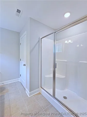 an empty room with ceiling fan and window