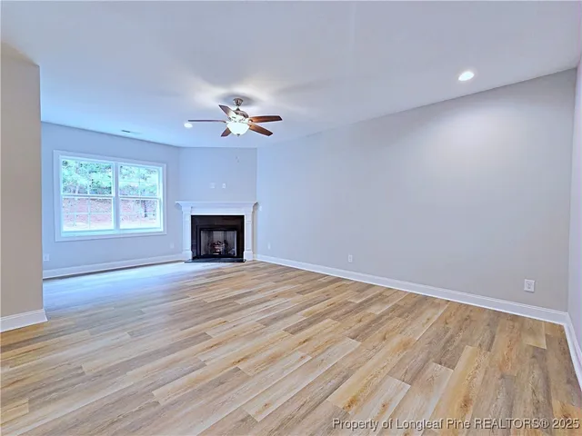 a living room with a fireplace with wooden floor
